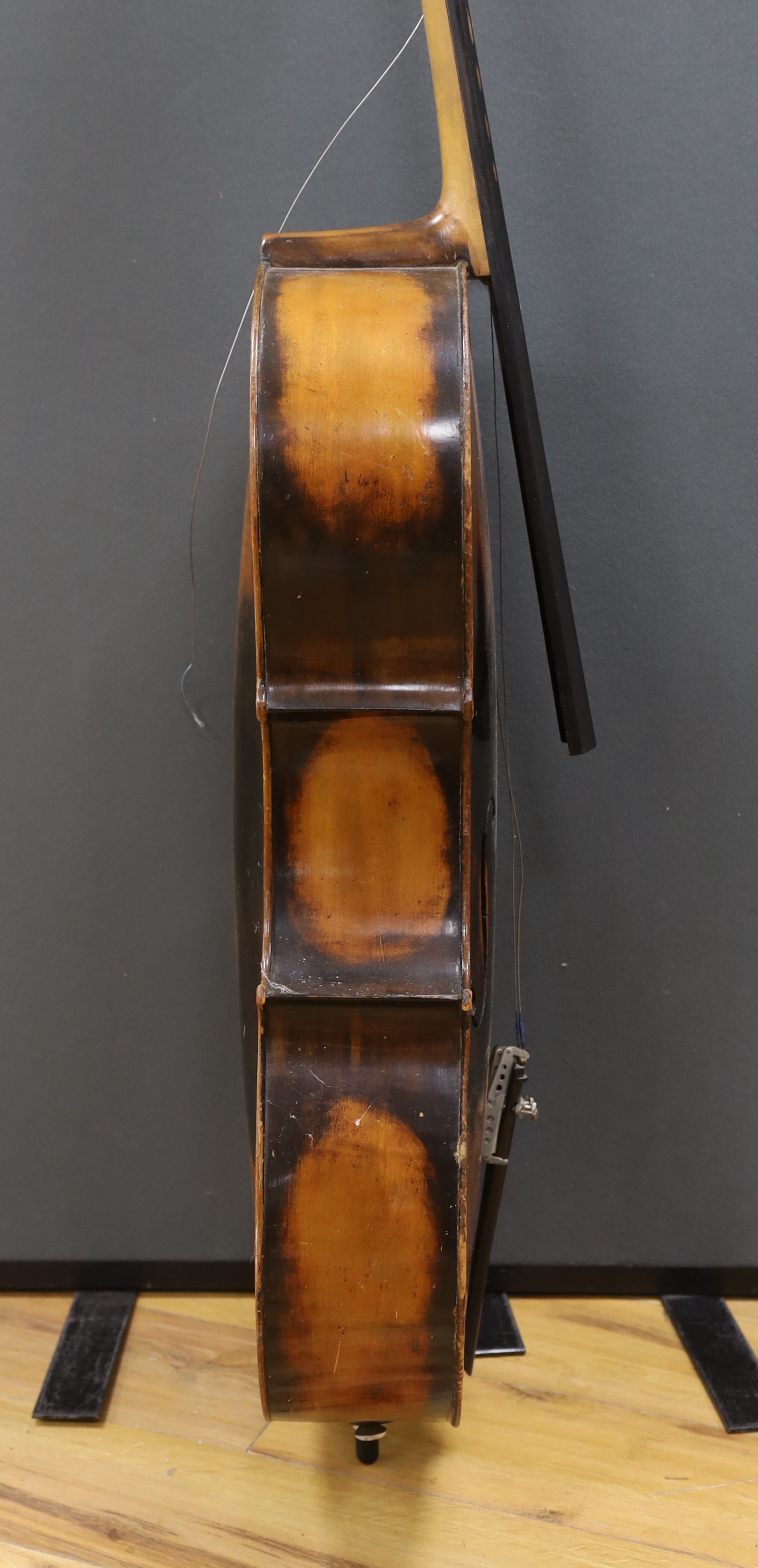 A full size cello labelled Adolf Stowaller, cased, 132cm high
